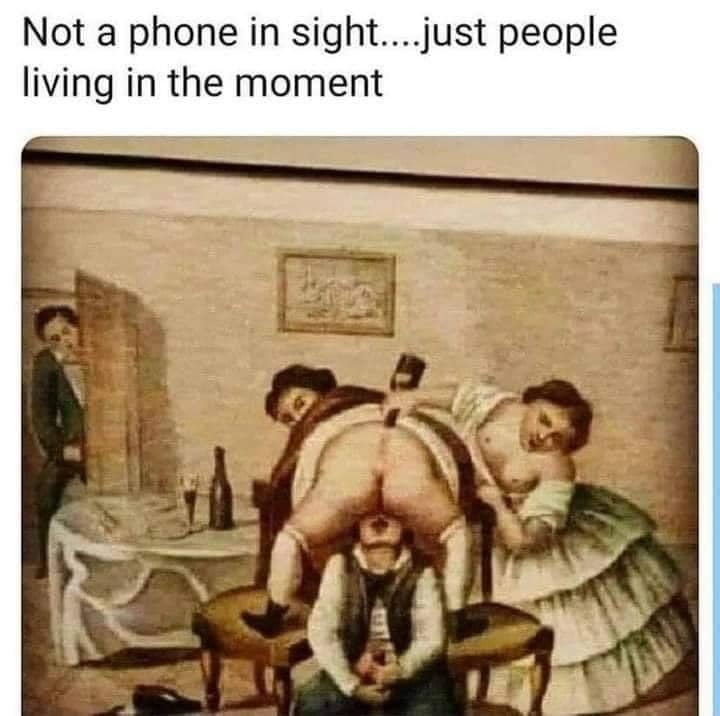 This meme is a humorous image of a family portrait from the 19th century, but with a twist. The original caption "Not a phone in sight... just people living in the moment" is ironic because the family is actually engaging in a rather... unusual activity. The text above the image pokes fun at the idea that people in the past were more carefree and didn't need to be constantly connected to their phones.